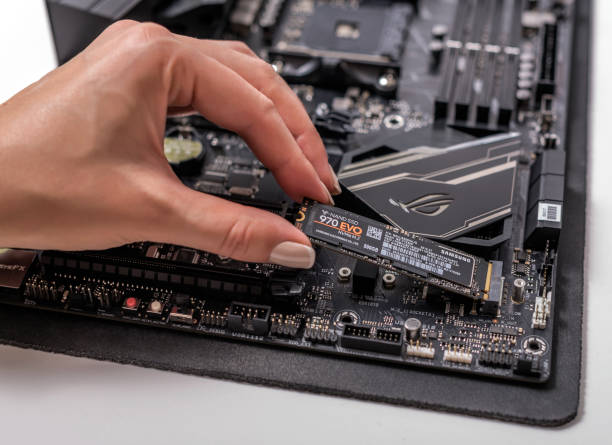 UZHGOROD, UKRAINE - October 25, 2018: Hard disk Samsung EVO 970 SSD m2 on the motherboard background. M2 technology can develop the speed of reading and writing information up to 3500 mbs.UZHGOROD, UKRAINE - October 25, 2018: Hard disk Samsung EVO 970 SSD m2 on the motherboard background. M2 technology can develop the speed of reading and writing information up to 3500 mbs.